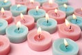 Burning colorful decorative candles on pink, space for text