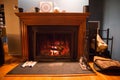 Burning cozy fireplace hearth with tools and gloves