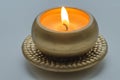 Burning decorative candle in gold color