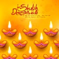 Burning diya on Diwali Holiday background for light festival of India with message in Hindi meaning Happy Dipawali Royalty Free Stock Photo