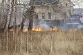 Burning dry grass, forest spring fires. Firefighters extinguish fire. Azov German national district of Omsk region, Russia, 18.04.