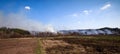 Burning dry grass in spring in the fields of Ukraine. Royalty Free Stock Photo