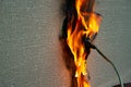 Burning electrical wiring and electrical outlet. Faulty wiring causes fires. Poor old wiring causes a fire in the electrical