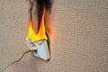 Burning electrical wiring and electrical outlet. Faulty wiring causes fires. Poor old wiring causes a fire in the electrical