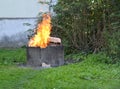 Burning empty cardboard boxes in a concrete ring