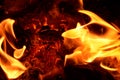 Burning fabric on a hot coal anthracite. Royalty Free Stock Photo