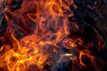 Burning fire close up. Bright orange and red flames on a dark background. Open flame heating. Problems with heating and gas Royalty Free Stock Photo