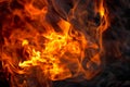 Burning fire close up. Bright orange and red flames on a dark background. Open flame heating. Problems with heating and gas