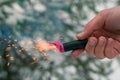 Burning Firecracker in a Hand. Sparks and Smoke of Petard Royalty Free Stock Photo