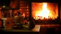 A burning fireplace with a cup of steaming coffee. Cozy home mood.