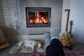 Burning fireplace and man feet