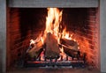 Burning fireplace, real wood logs, cozy warm home at xmas time Royalty Free Stock Photo