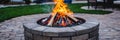 Burning Firewood in a Backyard Fire Pit Ready for Summer Evenings and Social Gatherings Royalty Free Stock Photo