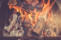Burning firewood in barbecue/burning brazier with firewood Royalty Free Stock Photo