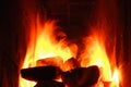 Burning firewood and coals in a stone stove. Brick oven on wood. Long tongues of flame of burning fire Royalty Free Stock Photo
