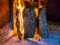 Burning firewood in the fireplace closeup, glowing logs, fire and flames Royalty Free Stock Photo