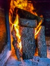 Burning firewood in the fireplace closeup, glowing logs, fire and flames Royalty Free Stock Photo