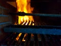 Burning firewood in the fireplace closeup, glowing logs, fire and flames Royalty Free Stock Photo