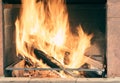 Burning firewood in the fireplace insert Royalty Free Stock Photo