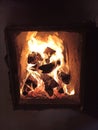 Burning firewood in furnace. Bright flame. Wood heating of izba, hut. Oven for cooking.