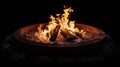 Burning firewood in a metal fire pit at night. High-contrast photography with focus on fire