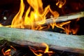 Burning Flames and Glowing Coal in BBQ, Warm orange bonfire with pieces of wood Royalty Free Stock Photo