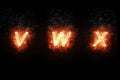 Burning font v, w, x, fire word text with flame and smoke on black background, concept of fire heat alphabet decoration Royalty Free Stock Photo