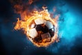 burning football soccer ball on fire is flying on blue isolated background. Sport burn element concept Royalty Free Stock Photo