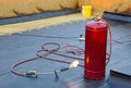 Burning gas burner on the roof with stone wool