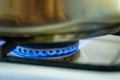 Burning gas of a kitchen stove. Blue fire under iron pot Royalty Free Stock Photo