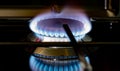 Burning gas stove blue flames close up in the dark on a black background Royalty Free Stock Photo