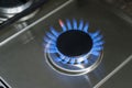 Burning gas, gas stove burner, hob in the kitchen. Blue gas stove in the dark Royalty Free Stock Photo