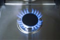 Burning gas, gas stove burner, hob in the kitchen. Blue gas stove in the dark Royalty Free Stock Photo