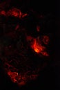 Burning and glowing charcoal close-up. Red coals with fire on a black background Royalty Free Stock Photo