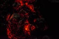 Burning and glowing charcoal close-up. Red coals with fire on a black background Royalty Free Stock Photo