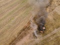 Burning grass on the field in village. Aerial view