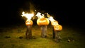 Burning halloween pumpkins on tree log in darkness, field, mist, dusk. Scary funny angry big orange pumpkin exhales fire