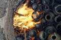 Burning handmade pottery pieces in earthen firing chamber of ancient pit fire kiln replica Royalty Free Stock Photo