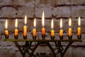 Burning hanukkah candles in a menorah on colorful candles from a menorah Royalty Free Stock Photo