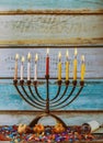 Burning hanukkah candles in a menorah on colorful candles from a menorah