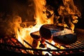 burning hot coals and lit fire for grilling food in backyard grill