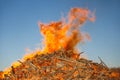 Burning huge bonfire against the blue sky Royalty Free Stock Photo