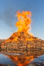 Burning huge bonfire against the blue sky Royalty Free Stock Photo