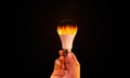 Burning Ideas Concept Background with Fire inside Bulb, Man Holding Bulb with Fire inside it. New ideas backdrop. Abstract Art des Royalty Free Stock Photo