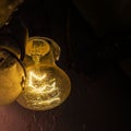 A burning incandescent light bulb on the wall, respect for electricity on planet earth, the foreground and background are blurred