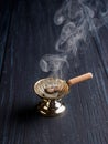 Burning incense in a simple censer