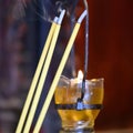 Burning incense sticks and oil in Asian Buddhist Temple, Saigon,Vietnam. Royalty Free Stock Photo