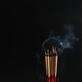 Burning incense white smoke black background used as a worship background image a sacred object of Buddhist beliefs focuses on the