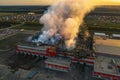 Burning industrial building with fire, huge thick smoke and burnt roof, aerial view Royalty Free Stock Photo