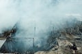 Burning industrial building. Smoke, collapsed roof, aerial view Royalty Free Stock Photo